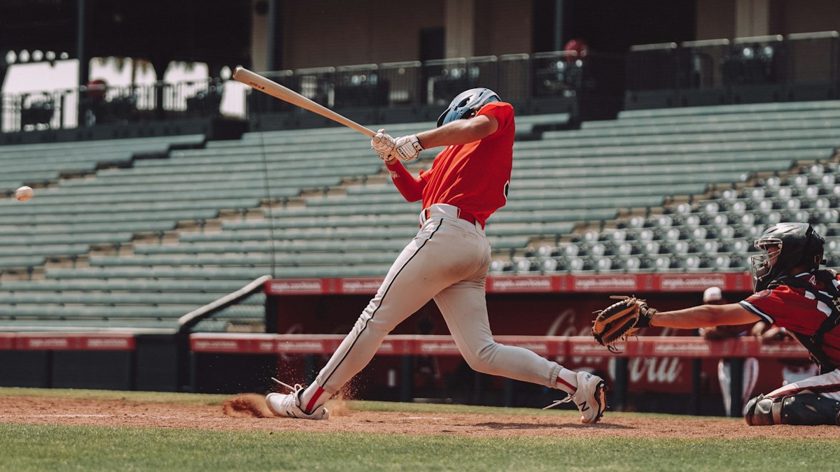 Baseball batter mid-swing